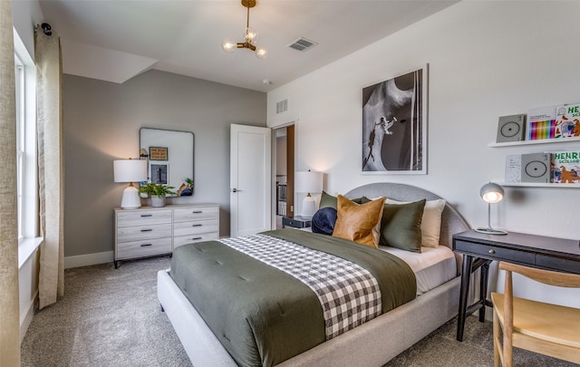 bedroom with visible vents, baseboards, an inviting chandelier, and carpet floors
