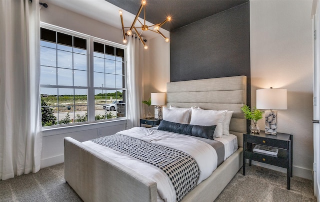 bedroom with carpet floors, baseboards, and an inviting chandelier
