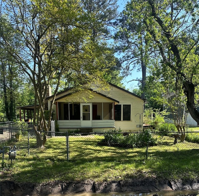 117 Spilker Ave, Shreveport, LA 71106 - rear view of house with a yard, a sunroom, and a fenced front yard