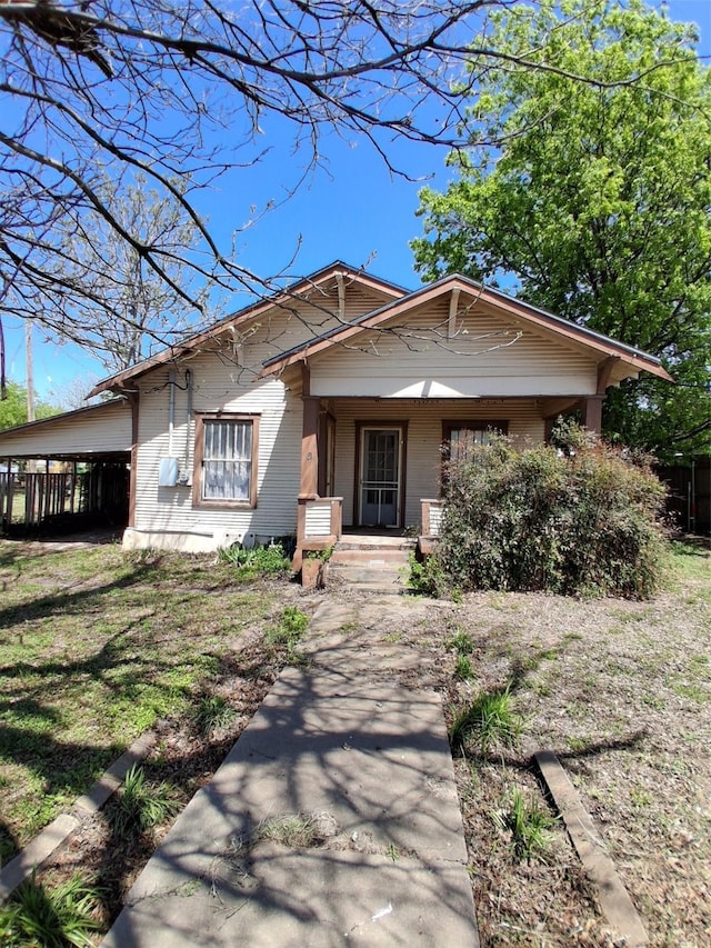 view of front of property with a front yard and covered porch