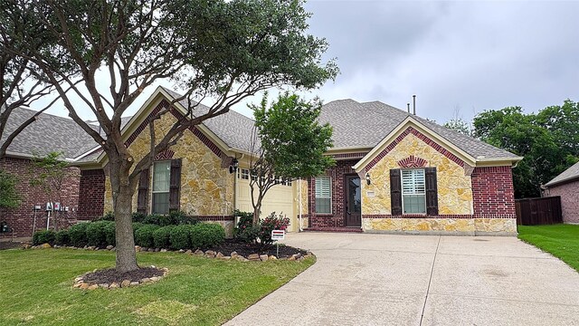 view of front facade with roof with shingles, a garage, fence, concrete driveway, and stone siding