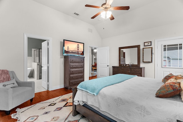 bedroom with lofted ceiling, baseboards, wood finished floors, and visible vents