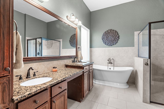 full bathroom with tile patterned flooring, a sink, double vanity, and a stall shower