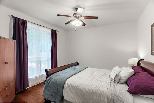 bedroom featuring a ceiling fan and dark wood-style floors