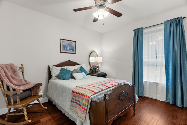 bedroom with ceiling fan, baseboards, and wood finished floors