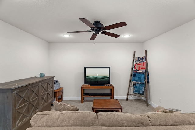living room featuring baseboards, carpet, and ceiling fan