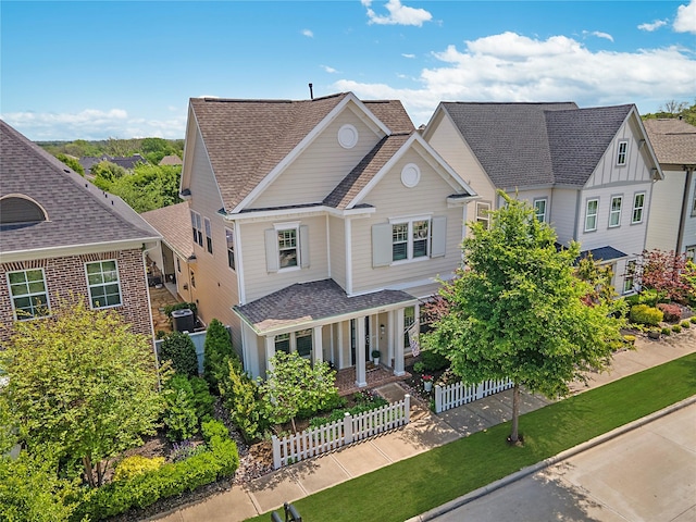 2208 Tremont Blvd, Mckinney, TX 75071 - traditional home featuring roof with shingles, covered porch, fence, and brick siding