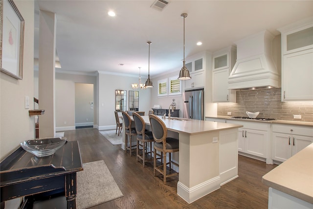 2208 Tremont Blvd, Mckinney, TX 75071 - kitchen with stainless steel refrigerator, custom range hood, a sink, gas cooktop, and tasteful backsplash