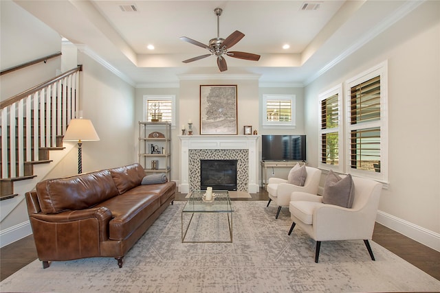 2208 Tremont Blvd, Mckinney, TX 75071 - living area featuring a tray ceiling, a ceiling fan, healthy amount of natural light, recessed lighting, and ornamental molding