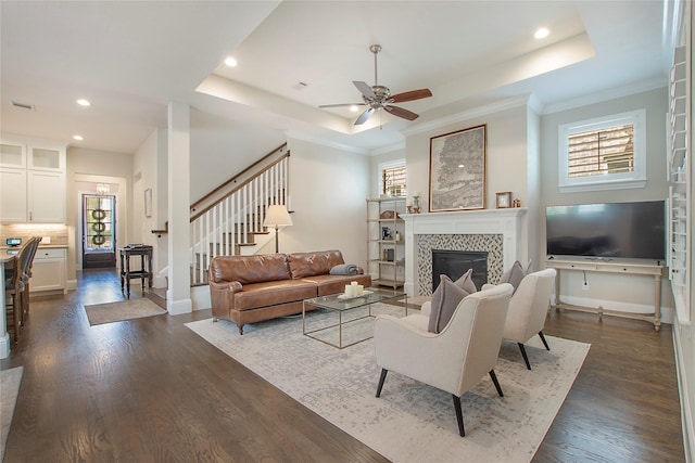 2208 Tremont Blvd, Mckinney, TX 75071 - living area with a raised ceiling, recessed lighting, dark wood-type flooring, ceiling fan, and stairs