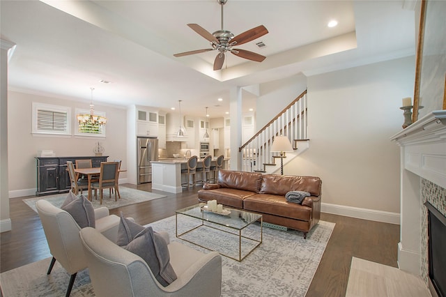 2208 Tremont Blvd, Mckinney, TX 75071 - living area featuring a ceiling fan, baseboards, a tiled fireplace, a chandelier, and dark wood-type flooring