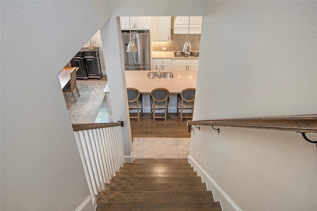 2208 Tremont Blvd, Mckinney, TX 75071 - stairs with wood finished floors, a textured wall, and baseboards