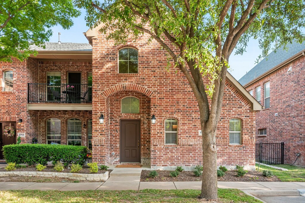 6792 Regello Dr, Frisco, TX 75034 - view of front of home with brick siding, a balcony, and fence