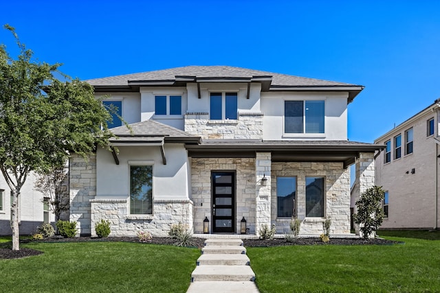 prairie-style house featuring stucco siding, a front lawn, and stone siding