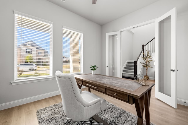 office space featuring baseboards and light wood-type flooring