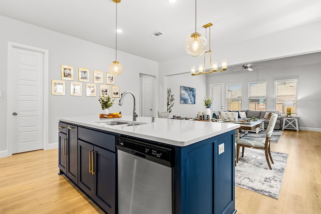 kitchen featuring a sink, light wood finished floors, dishwasher, light countertops, and a ceiling fan
