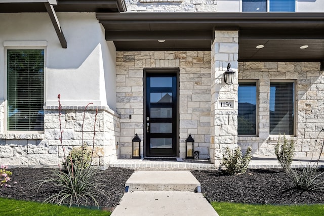 entrance to property with stone siding