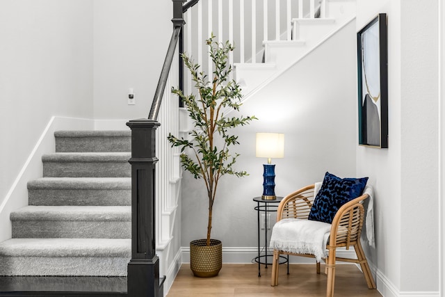 stairway with baseboards and wood finished floors