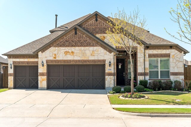 1304 Cold Stream Dr, Wylie, TX 75098 - french country style house featuring stone siding, an attached garage, roof with shingles, and driveway