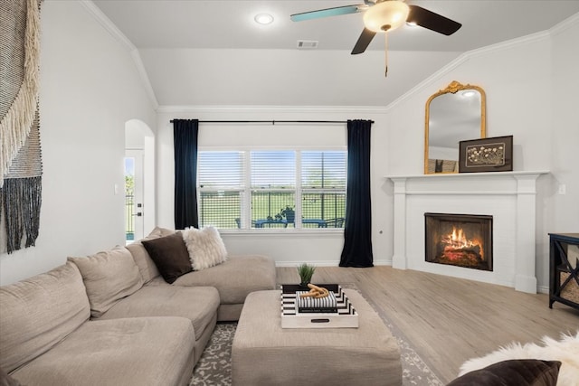 living area with wood finished floors, visible vents, a ceiling fan, and lofted ceiling