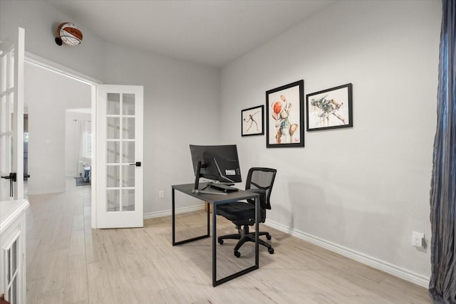 office area featuring french doors, baseboards, and light wood-style floors