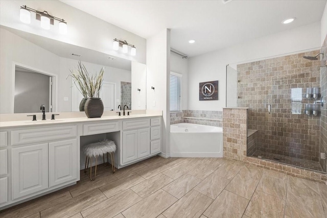 bathroom with double vanity, a bath, a sink, and a stall shower
