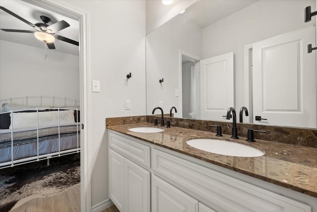 bathroom with a sink, ceiling fan, and double vanity