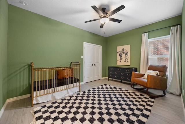 bedroom featuring ceiling fan, baseboards, and wood finished floors