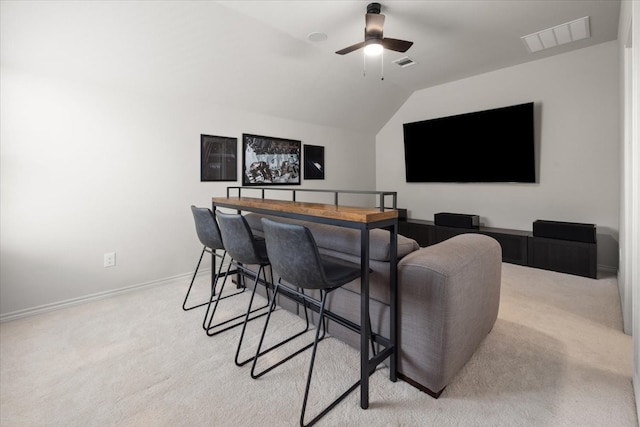 interior space featuring visible vents, baseboards, a ceiling fan, and vaulted ceiling
