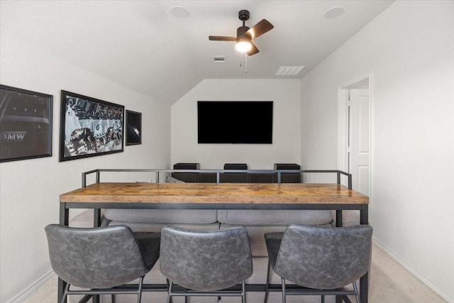 interior space featuring baseboards, carpet flooring, visible vents, lofted ceiling, and ceiling fan