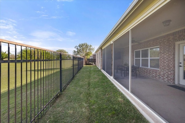view of yard with a sunroom and a fenced backyard