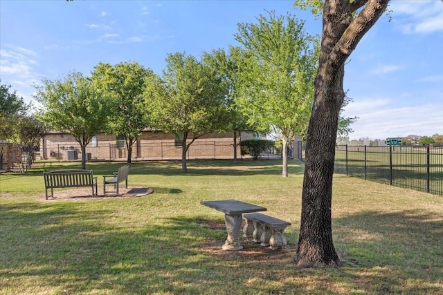 view of community with fence and a lawn