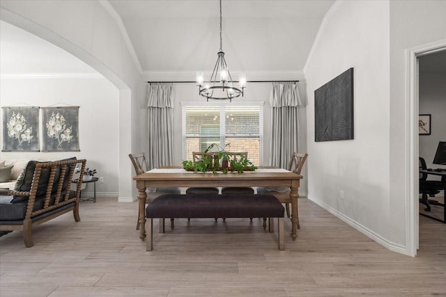 dining room with crown molding, baseboards, an inviting chandelier, and light wood-style flooring