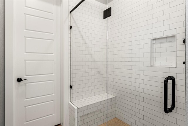 bathroom with a shower stall