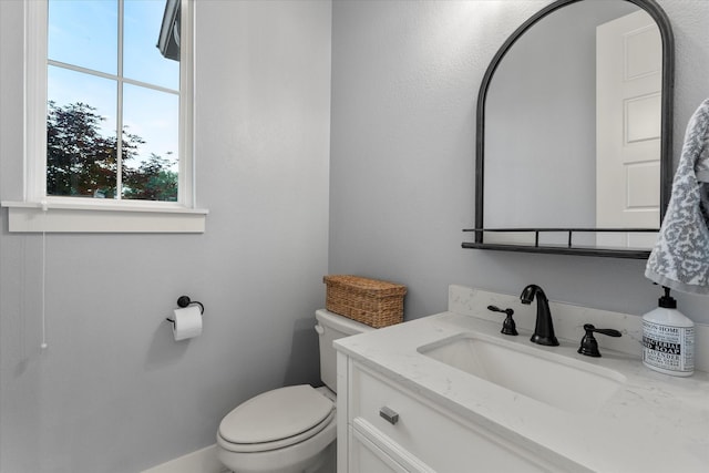 half bathroom with toilet and vanity