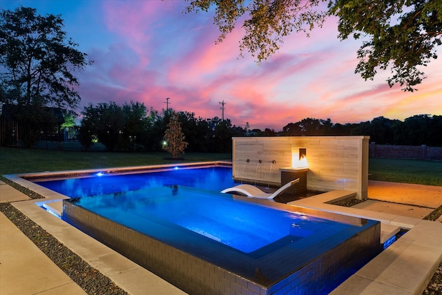 view of swimming pool featuring a patio area and a hot tub