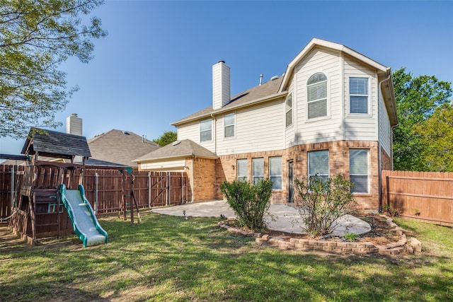 back of property with a fenced backyard, a lawn, a patio, a playground, and a chimney