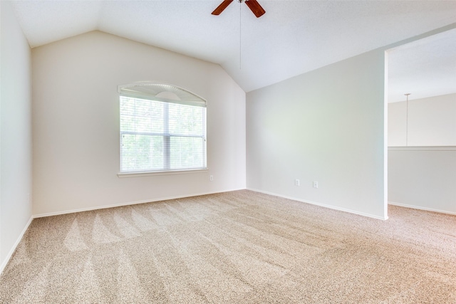 unfurnished room featuring a ceiling fan, lofted ceiling, and carpet floors