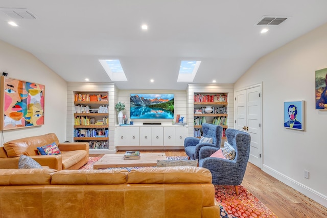 860 Prairie Trl, Argyle, TX 76226 - living area featuring baseboards, wood finished floors, visible vents, and vaulted ceiling with skylight