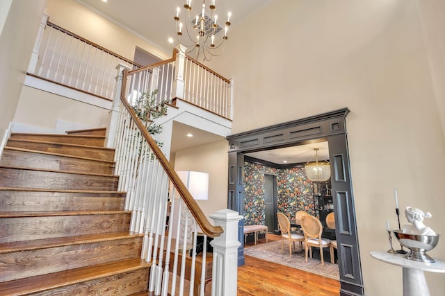 860 Prairie Trl, Argyle, TX 76226 - stairway with a towering ceiling, crown molding, wood finished floors, and a chandelier