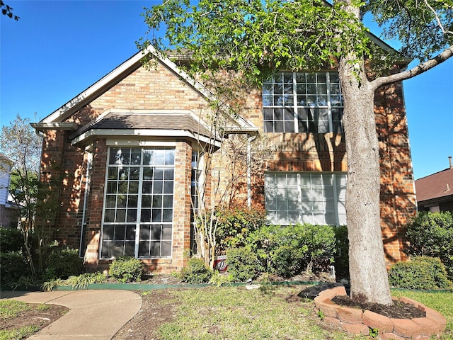 traditional-style house featuring brick siding