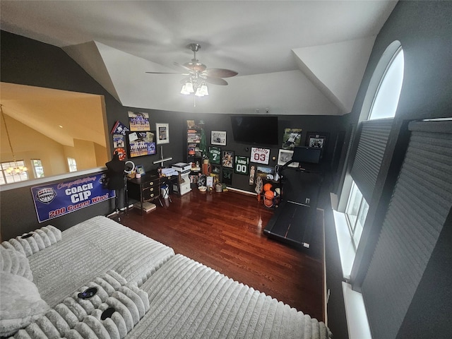 bedroom with ceiling fan, baseboards, wood finished floors, and lofted ceiling
