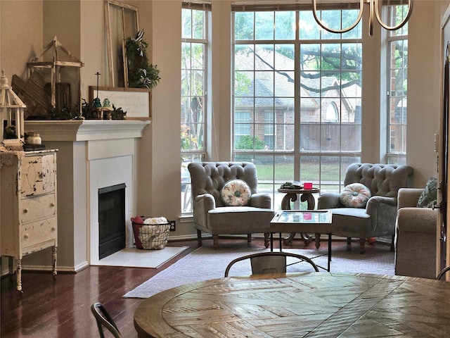 living room featuring a fireplace with flush hearth and wood finished floors