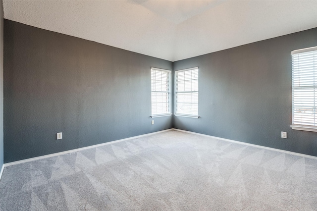 unfurnished room with carpet floors and baseboards