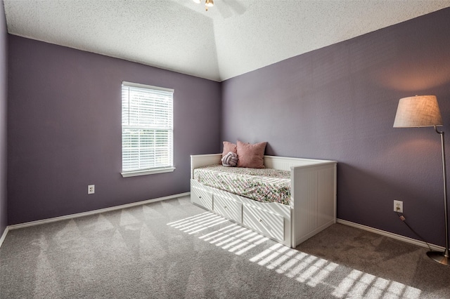 bedroom with carpet, a textured ceiling, baseboards, and lofted ceiling