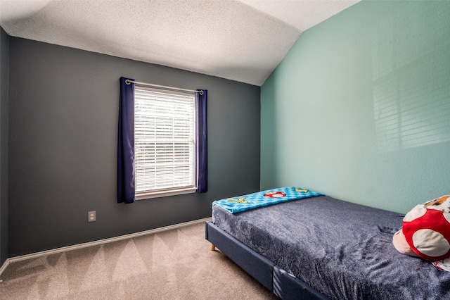 carpeted bedroom featuring vaulted ceiling, a textured ceiling, and baseboards