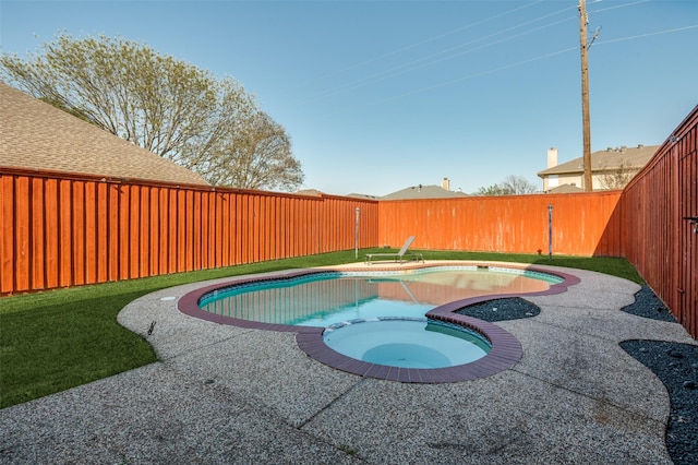 view of pool with a fenced backyard and a pool with connected hot tub