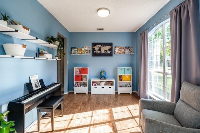 sitting room with wood finished floors and baseboards