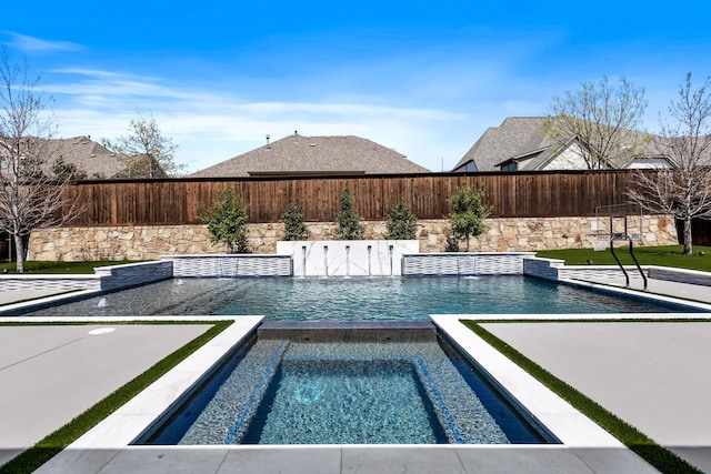 view of pool featuring a fenced backyard, an in ground hot tub, and a fenced in pool