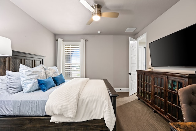 carpeted bedroom featuring baseboards, a ceiling fan, and visible vents